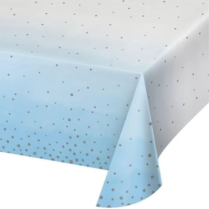 May include: A rectangular tablecloth with a gradient design, transitioning from white to light blue. The tablecloth is adorned with scattered gray polka dots. The fabric is folded over the edge, showcasing the design.