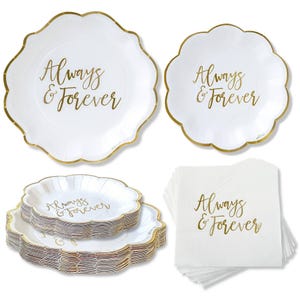 May include: White paper plates and napkins with gold scalloped edges. The plates and napkins have the words "Always & Forever" in gold script. The plates are in different sizes and stacked. Perfect for a wedding or anniversary.