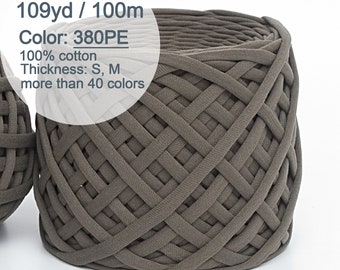 May include: A skein of 100% cotton yarn in a dark brown color. The yarn is 109 yards long and is labeled "380PE". The yarn is described as having a thickness of "S, M" and being available in over 40 colors.