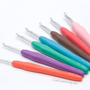 May include: A set of seven colorful crochet hooks with different sizes, ranging from 3.0 mm to 6.0 mm. The hooks are made of metal with a smooth, ergonomic handle.
