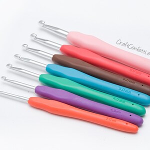 May include: A set of eight colorful crochet hooks with different sizes, ranging from 3.0 mm to 6.0 mm. The hooks are made of metal with plastic handles.