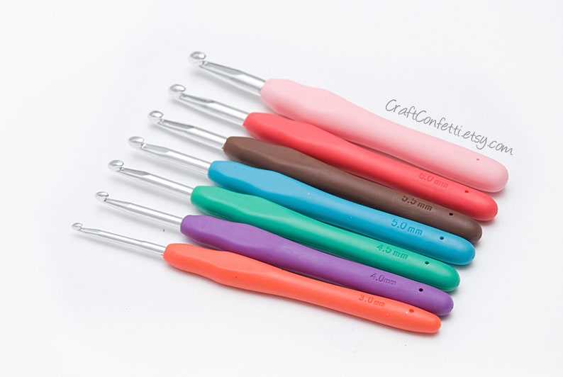 May include: A set of eight colorful crochet hooks with different sizes, ranging from 3.0 mm to 6.0 mm. The hooks are made of metal with plastic handles.
