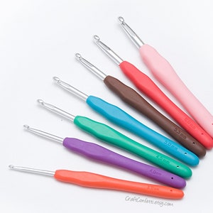 May include: A set of seven colorful crochet hooks with different sizes, ranging from 3.0 mm to 6.0 mm. The hooks are made of metal with plastic handles.