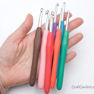 May include: A set of six colorful crochet hooks with ergonomic handles. The hooks are arranged in a fan shape and are labeled with their sizes in millimeters: 5.5 mm, 5.0 mm, 4.5 mm, 4.0 mm, 3.5 mm, and 3.0 mm.
