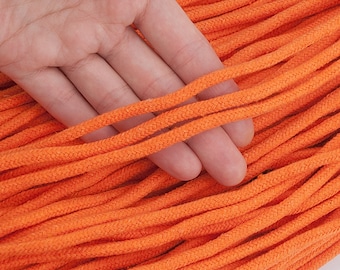 May include: A close-up of a large bundle of orange cotton cord. The cord is 5mm in diameter and 10 yards (9 meters) long.