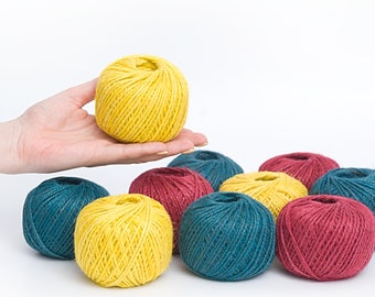 May include: Eight balls of twine in three colors: yellow, teal, and burgundy. The balls are 2 mm in diameter.