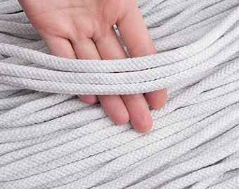 May include: Close-up of a bundle of light grey rope. The rope has a diameter of 8mm and a length of 9 metres. The rope is held by a hand. The text "Diameter: 8mm Length: 10yd (9m)" is at the top of the image.