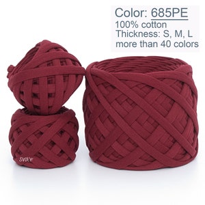 May include: Three balls of maroon colored 100% cotton yarn. The yarn is woven in a lattice pattern. The text "Color: 685PE", "100% cotton", "Thickness: S, M, L", and "more than 40 colors" is visible in the image.