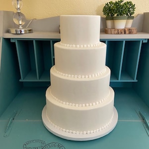 Four tier with bead borders faux wedding cake