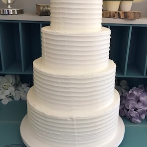 Four tier horizontal lines textured faux wedding cake