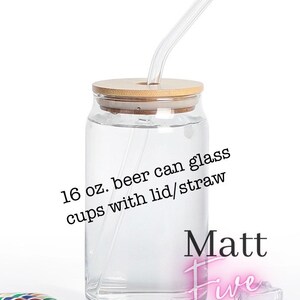 May include: A clear glass beer can cup with a bamboo lid and a clear straw. The cup is labeled "16 oz. beer can glass cups with lid/straw". The cup is on a white background.