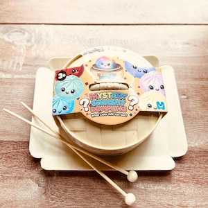 May include: A set of three ceramic mugs with a speckled, matte finish. The mugs are in shades of cream, light gray, and dark gray. Each mug has a simple, minimalist design, perfect for coffee or tea.