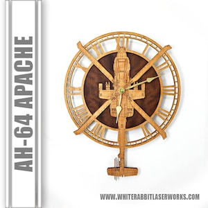 May include: A wooden wall clock featuring a detailed silhouette of an AH-64 Apache helicopter. The clock face has Roman numerals and a brown background. The helicopter is centered on the clock face and has a gold-colored clock hand.