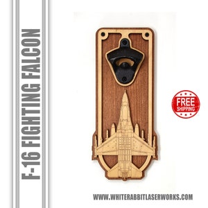 May include: Wooden bottle opener with a laser-engraved F-16 Fighting Falcon silhouette. The opener has a black metal bottle opener attached to the top. The background is white.