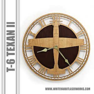 May include: A wooden wall clock featuring a T-6 Texan aircraft design. The clock face has Roman numerals and the aircraft is in the center. The clock hands are gold.