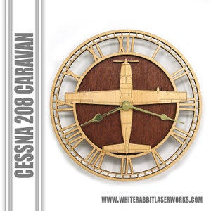 May include: A wooden wall clock featuring a cutout design of a Cessna 208 Caravan airplane with gold-colored hands. The clock face has Roman numerals and a brown wood background.