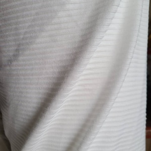 May include: White ribbed fabric with a soft, textured surface.