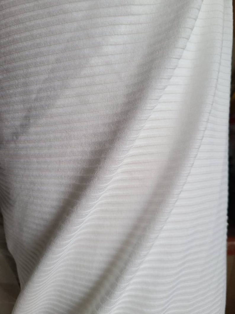 May include: White ribbed fabric with a soft, textured surface.