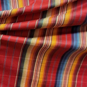 以下が含まれることがあります： 赤、黄、青、白のストライプ柄の織り生地です。