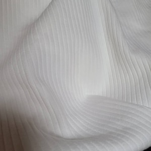 May include: White ribbed fabric with a soft, textured surface.