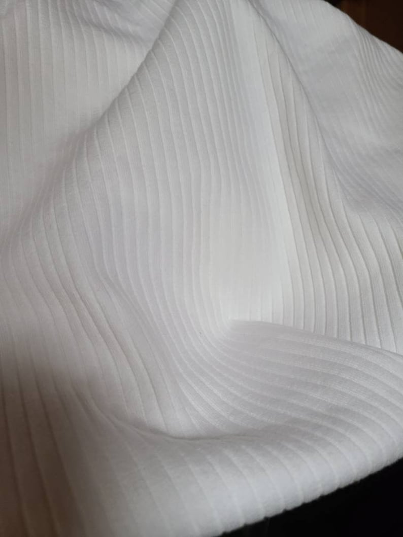 May include: White ribbed fabric with a soft, textured surface.