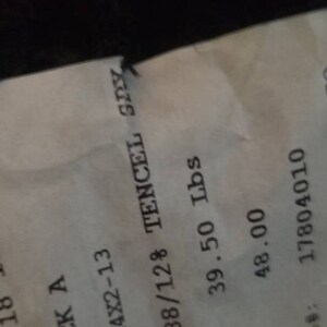 May include: A receipt with the date 02/13/18. The color is BLACK A, style TSR4X2-13, and fabric is 88/12% TENCEL SPY. The weight is 39.50 lbs, and the yard is 48.00. The piece number is 17804010.