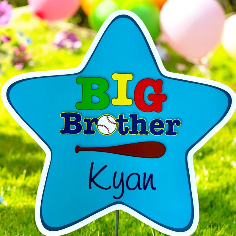 May include: Blue star-shaped sign with the text "BIG Brother Kyan" in colorful letters. A baseball and a brown baseball bat are also on the sign.