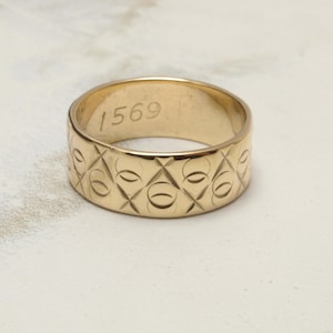Unusual 6.6mm wide wedding band in 9ct gold with engraved pattern