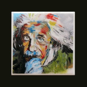 May include: A square ceramic tile featuring a colorful, impressionistic portrait of Albert Einstein. The artwork uses a palette of blues, greens, yellows, and reds to depict Einstein's face, hair, and clothing. The tile has a white border.
