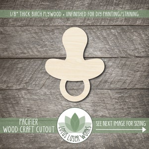 May include: Unfinished wooden pacifier cutout made from 1/8" thick birch plywood. The pacifier shape is ready for DIY painting or staining. The image also includes the text "PACIFIER WOOD CRAFT CUTOUT".
