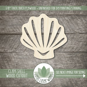 May include: Unfinished wooden clam shell cutout, 1/8 inch thick birch plywood.  The cutout is on a woodgrain background.  The text "CLAM SHELL WOOD CUTOUT" is at the bottom of the image.  The text "SEE NEXT IMAGE FOR SIZING" is at the bottom right of the image.  A logo for "Lotus Laser Works" is in the lower center of the image.