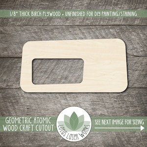 May include: Geometric atomic wood craft cutout, unfinished, made from 1/8 inch thick birch plywood.  The cutout is shaped like a rectangle with a smaller rectangular opening inside.  The wood is light brown in color.