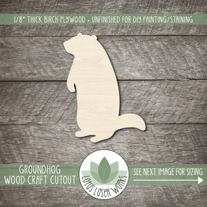 May include: A 1/8" thick unfinished birch plywood groundhog wood craft cutout. The groundhog is standing upright with its arms at its sides. The text "1/8" THICK BIRCH PLYWOOD • UNFINISHED FOR DIY PAINTING/STAINING" is at the top. The text "GROUNDHOG WOOD CRAFT CUTOUT" is at the bottom.