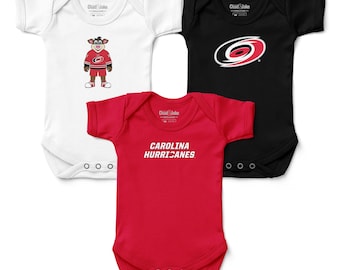 May include: Three baby onesies in white, black, and red. The white onesie features a cartoon mascot in a hockey jersey. The black onesie has a team logo. The red onesie displays the text "CAROLINA HURRICANES".