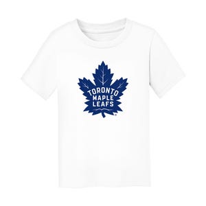 May include: White t-shirt featuring a blue maple leaf logo with the text "TORONTO MAPLE LEAFS". The logo is centered on the front of the shirt. The shirt has short sleeves and a crew neck.
