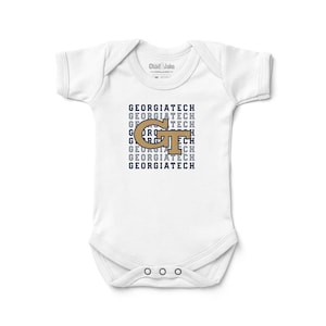 May include: White baby onesie with the text "GEORGIATECH" in navy blue and a gold "GT" logo. The onesie has short sleeves and three snaps at the bottom.