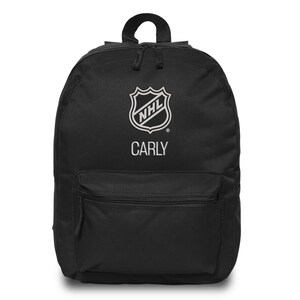 May include: Black backpack with the NHL logo and the name "CARLY" in white. The backpack has a top handle, a front zippered pocket, and two zippered compartments. A practical and stylish bag for everyday use.