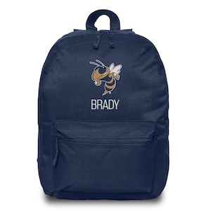 May include: Navy blue backpack with a front pocket and a top handle. The backpack features a cartoon bee logo with the name "BRADY" printed below it in white. The bee is gold, black, and white.