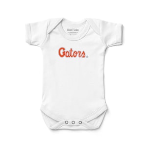 May include: A set of three ceramic mugs with a speckled, matte finish. The mugs are in shades of cream, light gray, and dark gray. Each mug has a simple, modern design and a rounded handle. Perfect for coffee or tea.