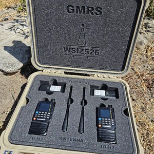 May include: Tan hard case with black foam interior, holding two black handheld radios, antennas, and batteries. The case is labeled "GMRS" and "WSIZ526". Each radio is labeled "TD-H3".