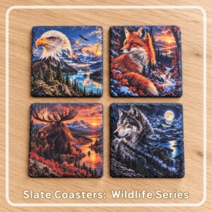 May include: A set of four square slate coasters featuring detailed wildlife illustrations. The designs include a bald eagle, a red fox, a moose, and a gray wolf, all set against vibrant mountain and forest landscapes. Text reads: Slate Coasters: Wildlife Series.