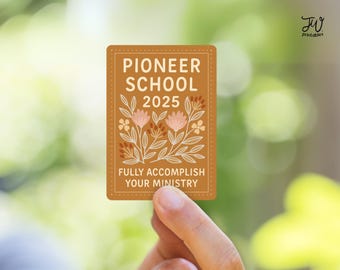 May include: A rectangular sticker with a brown background and floral illustrations. The text "PIONEER SCHOOL 2025" is at the top, with "FULLY ACCOMPLISH YOUR MINISTRY" at the bottom. The sticker is held by a hand.