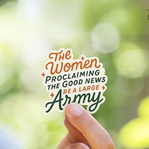 May include: A sticker with the text "The Women Proclaiming The Good News Are A Large Army" in green and orange lettering on a white background.