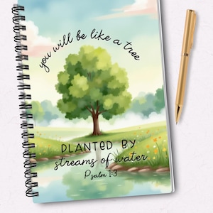 May include: A spiral bound notebook with a watercolour illustration of a tree planted by streams of water. The notebook cover features the text "you will be like a tree planted by streams of water" and "Psalm 1:3".