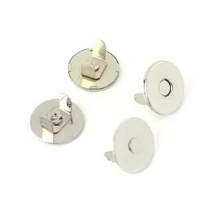 May include: Four silver magnetic snaps with a loop on the back for sewing. The snaps are round and have a flat surface.