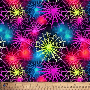 May include: A fabric pattern featuring neon yellow, hot pink, and electric blue spiderwebs against a black background. A ruler is positioned at the bottom, showing measurements in centimeters up to 30 cm for scale and reference.