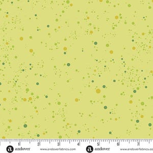 May include: A yellow fabric with a scattered pattern of green and gold circles of varying sizes.