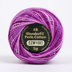 May include: A skein of purple and white WonderFil Perle Cotton embroidery thread. The label reads "#8 WonderFil Perle Cotton 100% Egyptian Cotton Double Gassed & Mercerized EZM1003 5g".