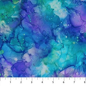 May include: Abstract fabric with a watercolour effect in shades of blue, teal, and purple. The design features flowing, blended colours with white accents. The ruler at the bottom shows measurements in inches.