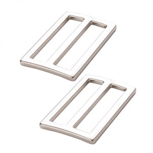 May include: Two silver metal slider buckles. The buckles are rectangular with a rounded edge and have a single slot in the center.